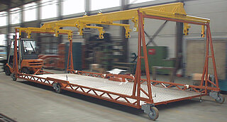 Installation and transport carriage for underground side wall segments Installation and transport carriage for underground side wall segments. The segments are taken out of the paint shop by means of a special traverse and then they are positioned and completed in the installation carriage