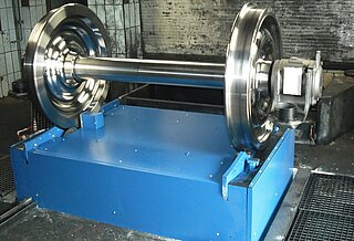 Lifting and rolling device: fixed track width: On the device there is a wheelset. You can see only the upper part of the device, because this lifting-rolling device is embedded in a pit on site.